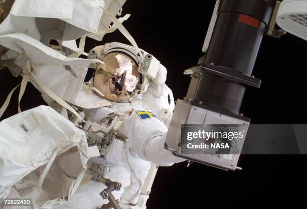 In this NASA handout photo European Space Agency astronaut Christer Fuglesang, STS-116 mission specialist, prepares to replace a faulty TV camera on...