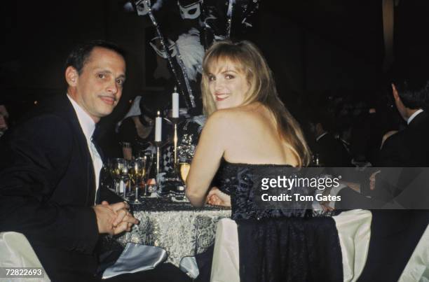 American film director John Waters dining out with American heiress Patty Hearst, circa 1990.