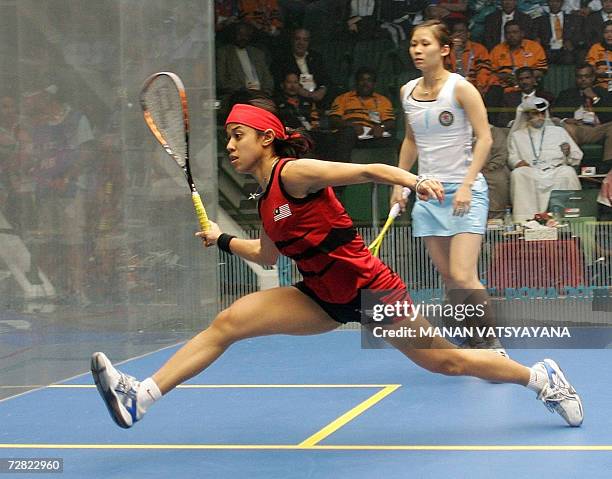 World squash number one Nicol David of Malaysia competes against defending champion Rebecca Chiu of Hong Kong in their women's squash singles gold...