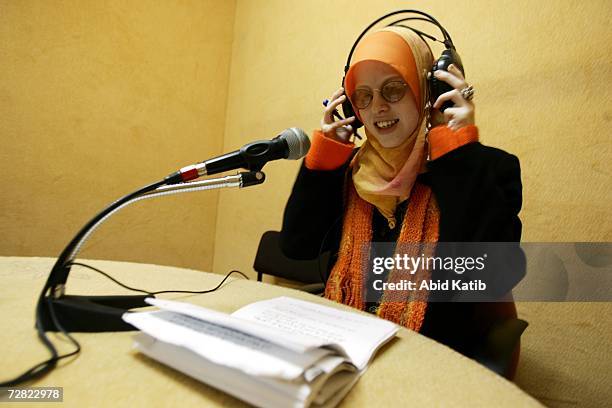 Palestinian radio announcer Rasha Zaqot who is visually impaired, stands by to read the news in the studio of Al Eradah Voice radio station in...