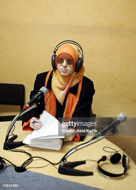 Palestinian radio announcer Rasha Zaqot who is visually impaired, stands by to read the news in the studio of Al Eradah Voice radio station in...