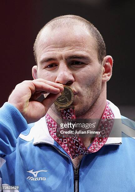 Artur Taymazov of Uzbekistan celebrates gold during the Men's Freestyle 120kg medal ceremony at the 15th Asian Games Doha 2006 in the Aspire Hall on...