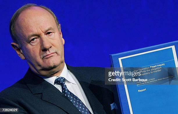 The former Commissioner of London's Metropolitan Police, Lord Stevens holds a copy of the Operation Paget inquiry report after an official British...
