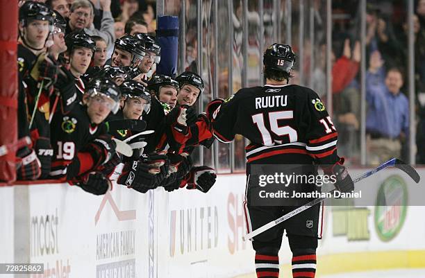 Tuomo Ruutu of the Chicago Blackhawks high fives his teammates as he skates by the bench during the NHL game against the Phoenix Coyotes on December...
