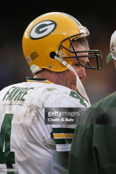 Quarterback Brett Favre of the Green Bay Packers talks with head coach Mike McCarthy as the game winds down against the San Francisco 49ers on...