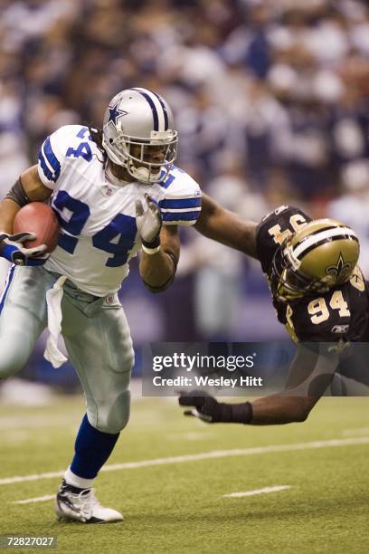 Running back Marion Barber of the Dallas Cowboys tries to avoid a tackle during a game against the New Orleans Saints at Texas Stadium on December...