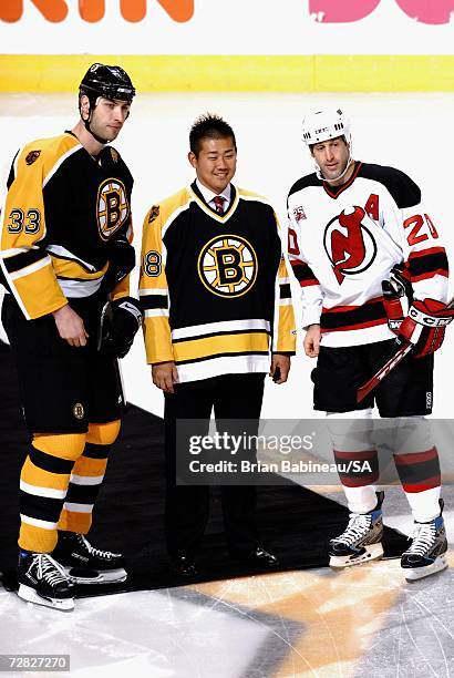 Daisuke Matsuzaka of the Boston Red Sox, Zdeno Chara of the Boston Bruins and Jay Pandolfo of the New Jersey Devils pose for a photo before the game...