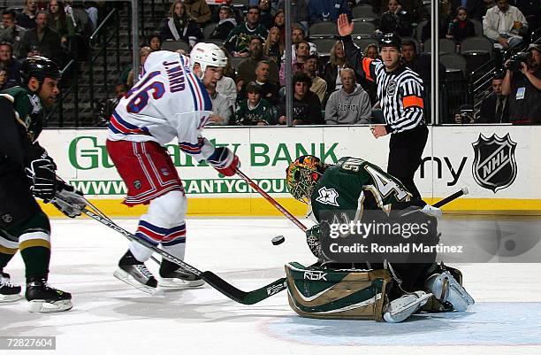 Goalie Mike Smith of the Dallas Stars makes a save against Jason Ward of the New York Rangers in the second period at the American Airlines Center on...