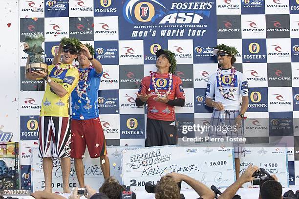 Former three times ASP World Champion Andy Irons of Hawaii is presented with his trophy after he sealed his fourth Rip Curl Pro Pipeline Masters...