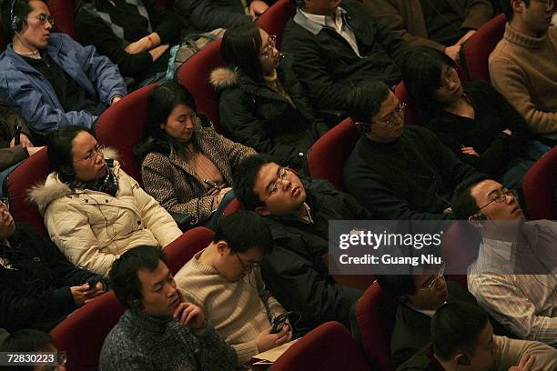 Chinese audience members listen to U.S. Federal Reserve Chairman Ben Bernanke making a speech at Chinese Academy of Social Sciences on December 15,...