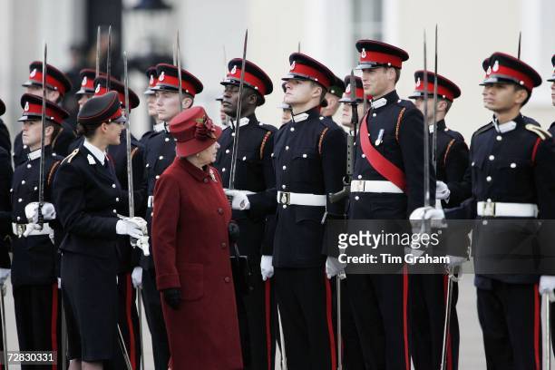 Queen Elizabeth II and her grandson Prince William smile as she inspects soldiers at the passing-out Sovereign's Parade at Sandhurst Military Academy...