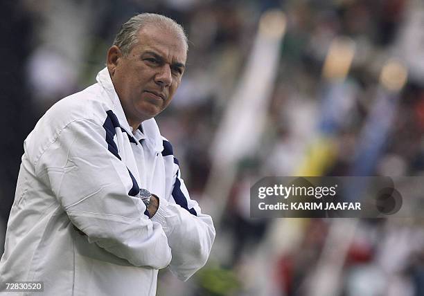 Iraq's coach Yahya Manhel looks on at the start of the men's football final between Iraq and Qatar at Al-Sadd Sports Club during the 15th Asian Games...