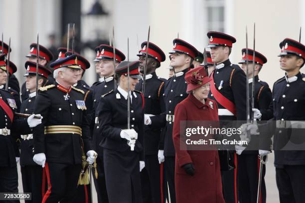 Queen Elizabeth II and her grandson Prince William smile as she inspects soldiers at the passing-out Sovereign's Parade at Sandhurst Military Academy...