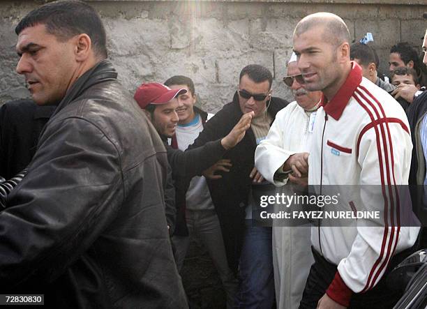 French football star Zinedine Zidane is escorted by bodyguards upon his arrival to his family's home in Aguemoune, 300 kms east of Algiers Algiers...