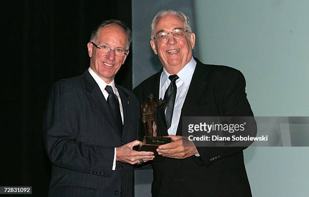 Glen Sonmor poses with Mike "Doc" Emrick as he accepts the Lester Patrick Award during a ceremony on November 6, 2006 at the Joe Louis Arena in...