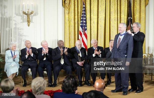 Washington, UNITED STATES: US President George W. Bush presents the medal to writer William Safire during a ceremony for the 2006 recipients of the...