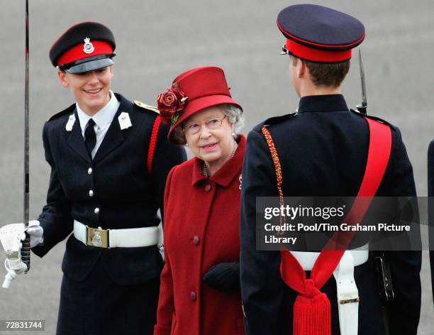 Queen Elizabeth II smiles at her grandson Prince William as she inspects soldiers passing out at the Sovereign's Parade at Sandhurst Military Academy...