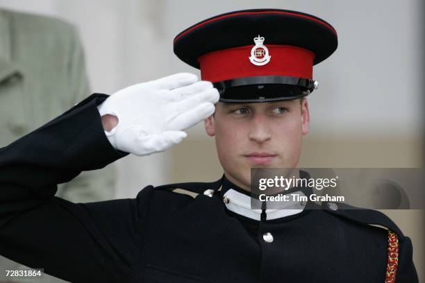 Prince William salutes during the Sovereign's Parade at Sandhurst Military Academy, passing-out as a commissioned officer on December 15, 2006 in...