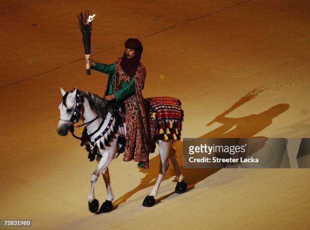Horseman holds the flame during the Closing Ceremony of the 15th Asian Games Doha 2006 at the Khalifa Stadium on December 15, 2006 in Doha, Qatar.
