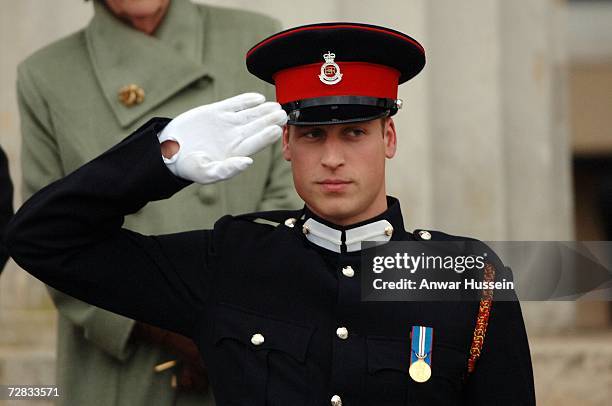 Prince William salutes after being commissioned as an officer in the British Army during the Sovereign's Parade at the Royal Military Academy...