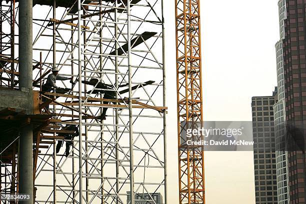 Workers set up scaffolding as the development of the mega-project L.A. Live entertainment complex continues next to Staples Center sports arena...