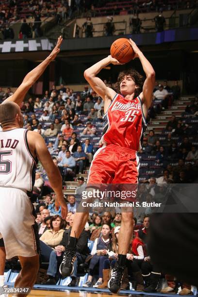 Adam Morrison of the Charlotte Bobcats shoots against the New Jersey Nets on November 28, 2006 at Continental Airlines Arena in East Rutherford, New...