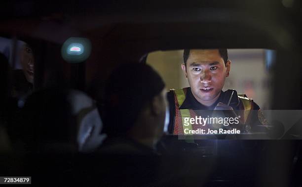 Officer L. Arias from the City of Miami police department questions a driver at a DUI checkpoint December 15, 2006 in Miami, Florida. The city of...