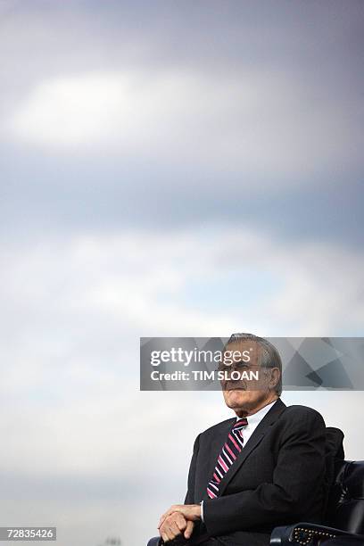 Washington, UNITED STATES: Outgoing Secretary of Defense Donald Rumsfeld listens during an Armed Forces Full Honor Review in his honor 15 December,...