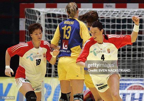 Hungary's Ibolya Mehlmann celebrates a goal together with teammate Piroska Szamoransky on Swedish goalkeeper Madeleine Grundstrom as the teams play...