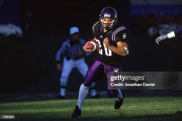 Damien Anderson of the Northwestern Wildcats runs with the ball during the game against the Michigan Wolverines at the Ryan Field in Evanston,...