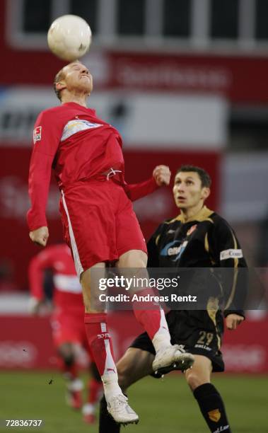 Ludovic Magnin of Stuttgart challenges for a header with Sergiu Radu of Cottbus during the Bundesliga match between Energie Cottbus and VFB Stuttgart...