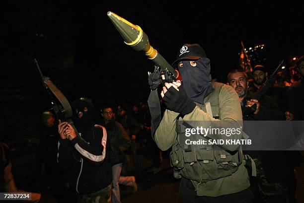 Palestinian militant, supporter of the ruling Hamas movement, holds a rocket propelled grenade on his shoulder during a demonstration in Gaza City 16...