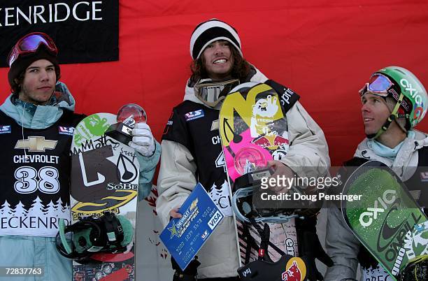 Danny Davis of the USA takes the podium after winning the finals of the halfpipe competition along with Mason Aguirre of the USA in second and Tommy...