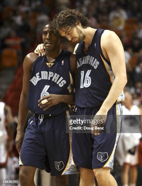 Eddie Jones and Pau Gasol of the Memphis Grizzlies walk off the court late in the first half against the Miami Heat at American Airlines Arena on...