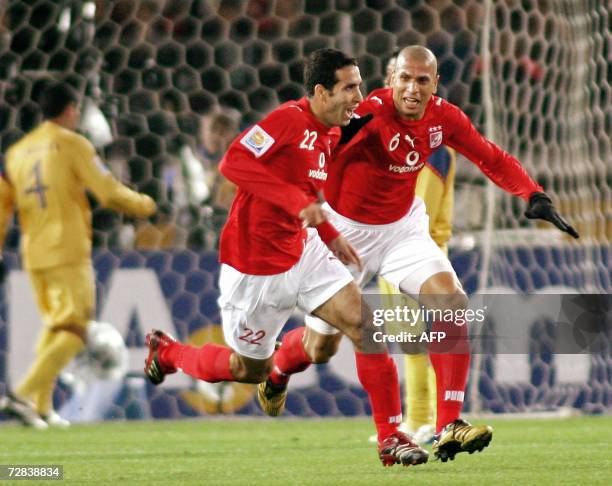 Egyptian Al-Ahly forward Mohamed Aboutrika is joined by his teammate Wael Gomaa after scoring a free kick against Mexico's Club America during the...