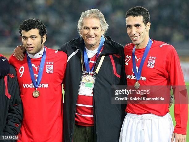 Emad Moteab, Coach Manuel Jose and Mohamed Aboutrika celebrate after defeating Club America by 2-1 during the FIFA Club World Cup Japan 2006 third...