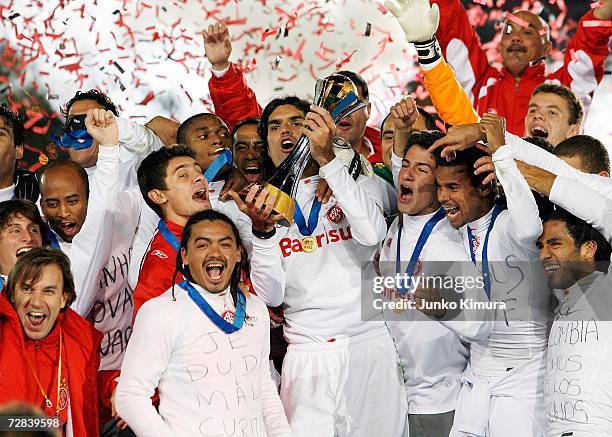 Players of Sport Club Internaciona celebrate with the cup after winning the final of the FIFA Club World Cup Japan 2006 between Sport Club...