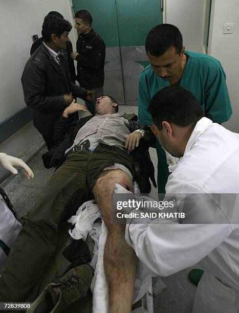 Veteran French journalist working for the French Liberation daily newspaper Didier Francois reacts as he is treated by medics at the al-Shifa...