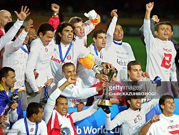 Brazil's SC Internacional players celebrate their victory over Spain's FC Barcelona during the awards of the FIFA Club World Cup in Yokohama,...