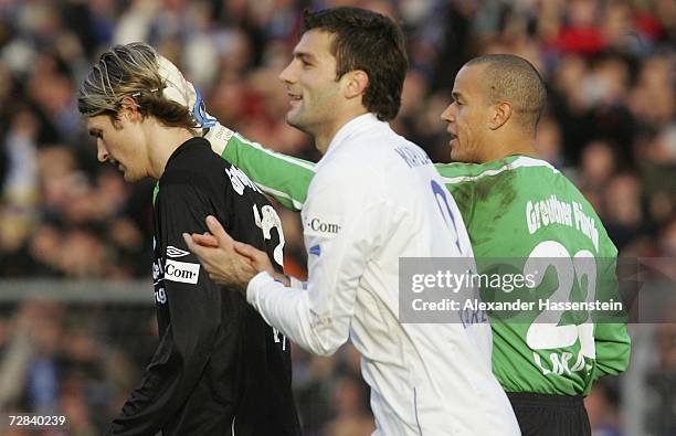 Furths keeper Stephan Loboue comforts his team mate Martin Lanig after he scored an own goal during the Second Bundesliga match between Karlsruher SC...