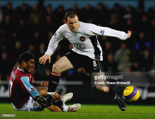 Wayne Rooney of Manchester United is challenged by Hayden Mullins of West Ham United during the Barclays Premiership match between West Ham United...