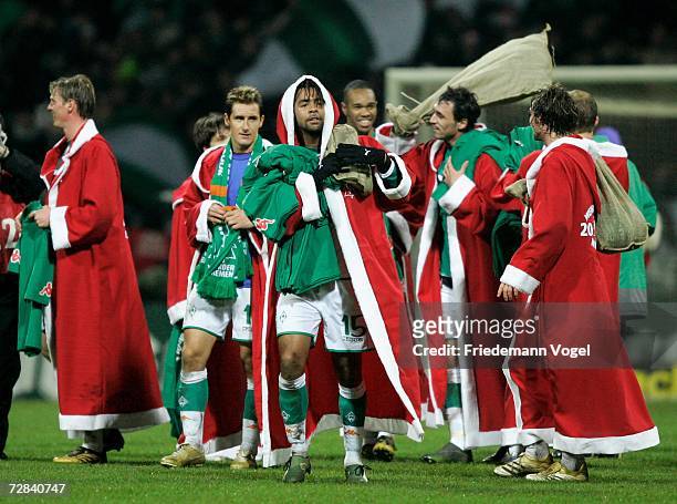 Werder players wear Santa Claus coats as they celebrate after winning the Bundesliga match between Werder Bremen and VFL Wolfsburg at the Weser...