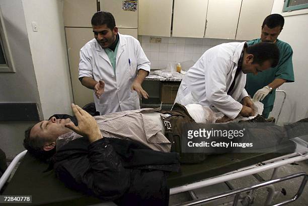 Veteran French journalist, Didier Francois, working for the French Liberation daily newspaper, is treated by medics at the al-Shifa Hospital after...