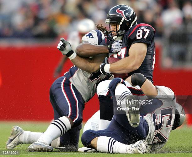 Mark Bruener of the Houston Texans is taken down by Tedy Bruschi $54 and Corey Mays of the New England Patriots on December 17, 2006 at Gillette...