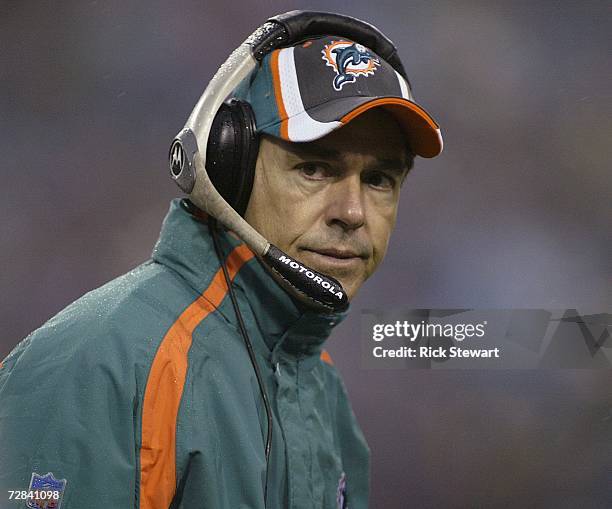 Nick Saban, head coach of the Miami Dolphins, stands on the sidelines in the fourth quarter of a 21-0 loss to the Buffalo Bills on December 17, 2006...