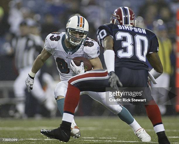Wes Welker of the Miami Dolphins tries to avoid Ko Simpson of the Buffalo Bills on December 17, 2006 at Ralph Wilson Stadium in Orchard Park, New...