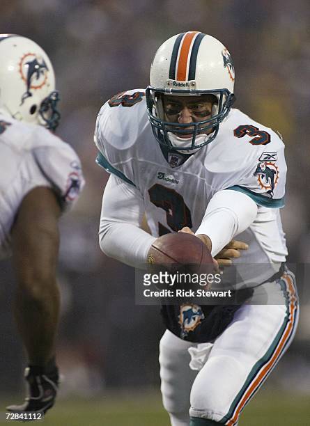 Joey Harrington of the Miami Dolphins hands off to Sammy Morris against the Buffalo Bills on December 17, 2006 at Ralph Wilson Stadium in Orchard...