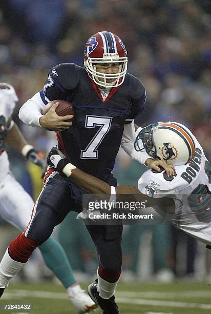 Losman of the Buffalo Bills is tackled by David Bowens of the Miami Dolphins on December 17, 2006 at Ralph Wilson Stadium in Orchard Park, New York....