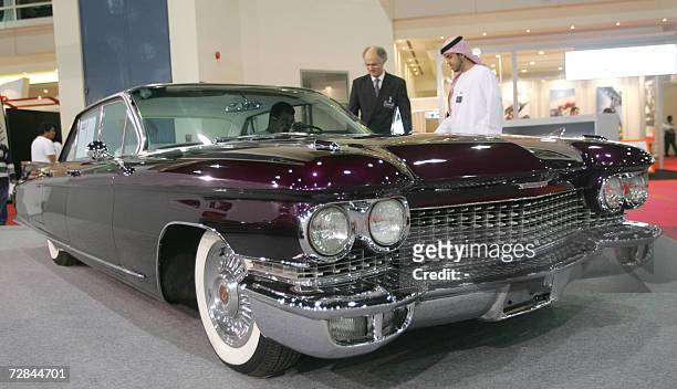 Abu Dhabi, UNITED ARAB EMIRATES: Emiratis look at a Cadillac ElDorado car during the Abu Dhabi Motor Show held at the International Exhibition Center...