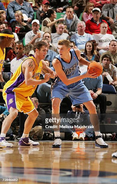 Andrei Kirilenko of the Utah Jazz looks to move the ball against Luke Walton of the Los Angeles Lakers on November 24, 2006 at EnergySolutions Arena...